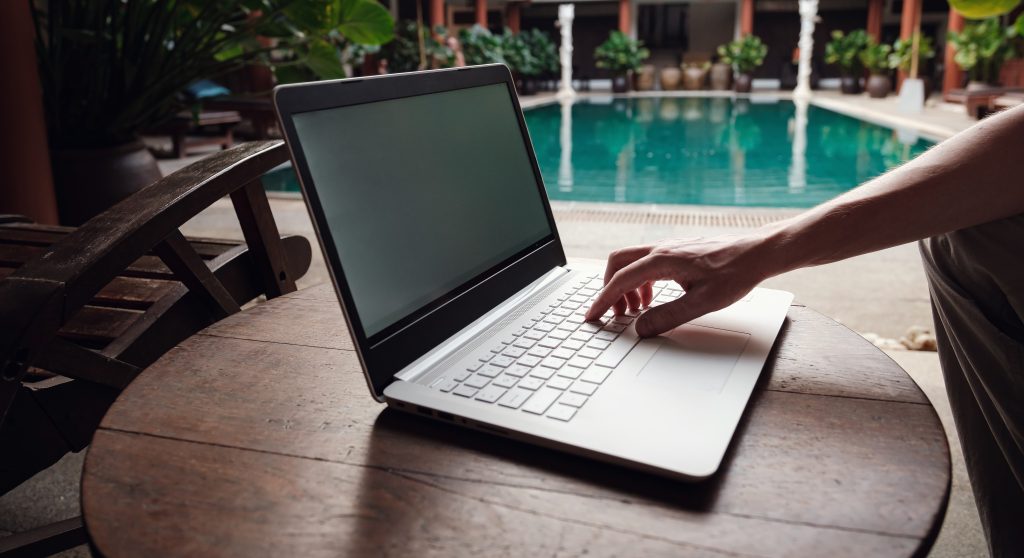 travel blogger sitting at swiming pool writing art 2022 07 01 18 13 59 utc